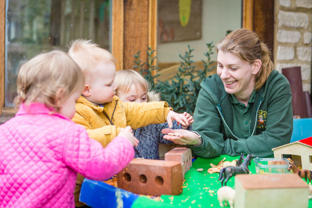 Some of the babies playing outside at Acorns Nursery School Cirencester.