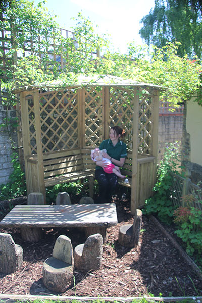 Eating in the Willow House in the garden at Acorns Nursery School Cirencester