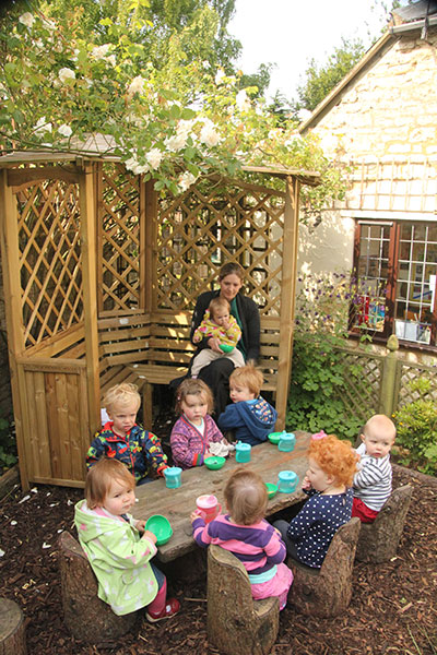 Eating in the Willow House in the garden at Acorns Nursery School Cirencester