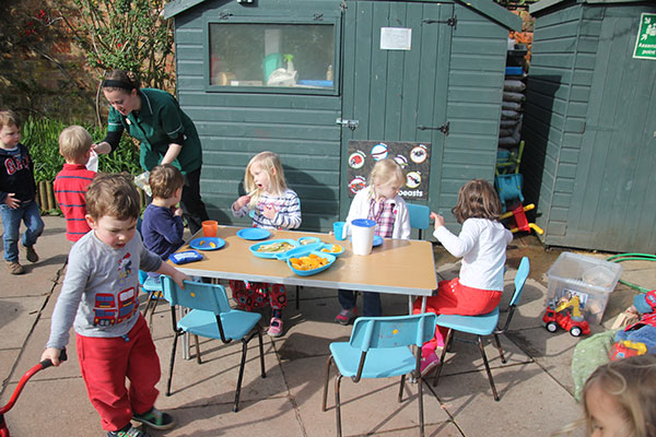 Eating outside at Acorns Nursery School in Cirencester.