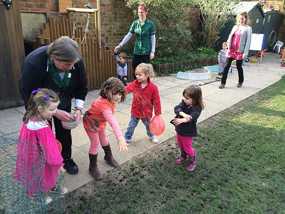 Children helping to seed the main lawn. 