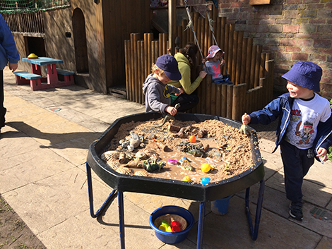 Playing in the garden at Acorns Nursery School, Cirencester.