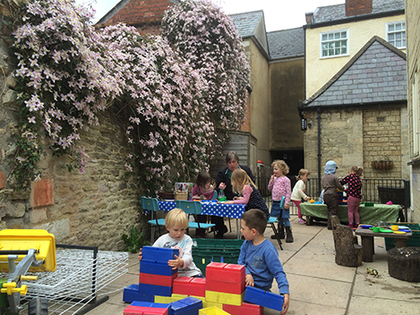 Clematis blooms over the Preschool Courtyard Classroom at Acorns Nursery School Cirencester.