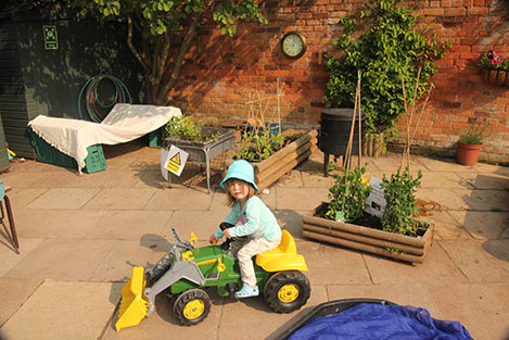 gardening Gardening with the (toy) tractor at Acorns Nursery School, Cirencester.