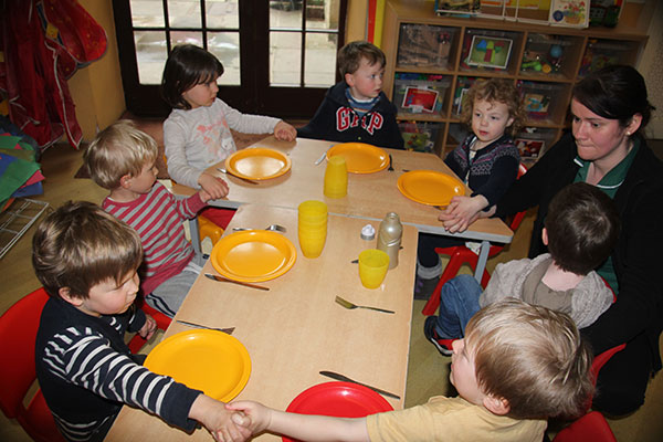 Giving thanks for the food at Acorns Nursery School in Cirencester.