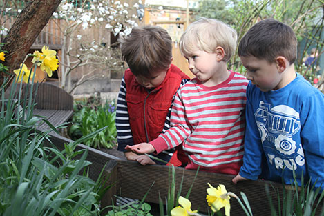 Examining the bug in the garden at Acorns Nursery School, Cirencester.