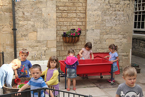 Clematis blooms over the Preschool Courtyard Classroom at Acorns Nursery School Cirencester.