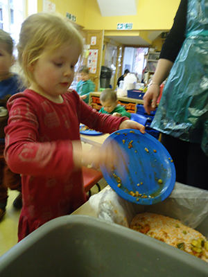 Cleaing up after lunch at Acorns Nursery School, Cirencester.