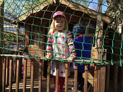 Feeding the lambs in the garden at Acorns Nursery School Cirencester