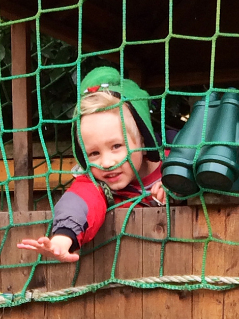 Feeding the lambs in the garden at Acorns Nursery School Cirencester