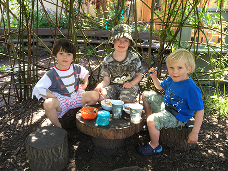 Eating in the Willow House in the garden at Acorns Nursery School Cirencester