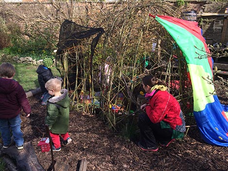 Eating in the Willow House in the garden at Acorns Nursery School Cirencester